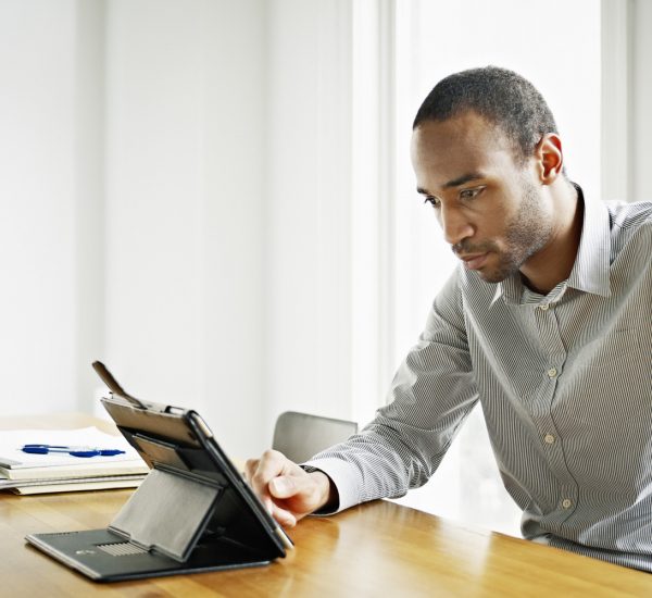 Businessman in office working on digital tablet