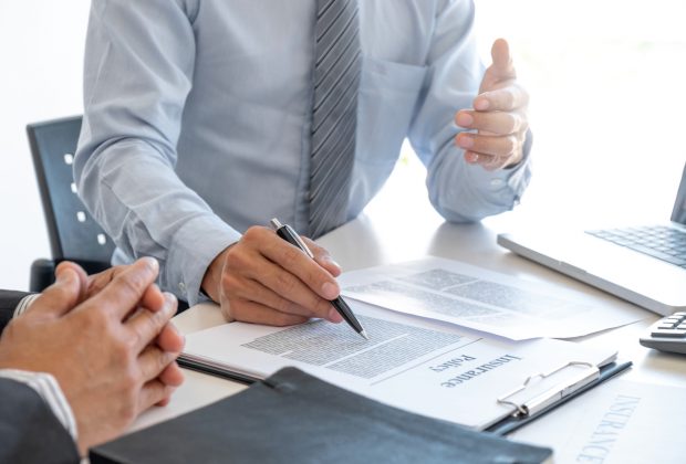 Insurance agent explaining insurance policy to customer.